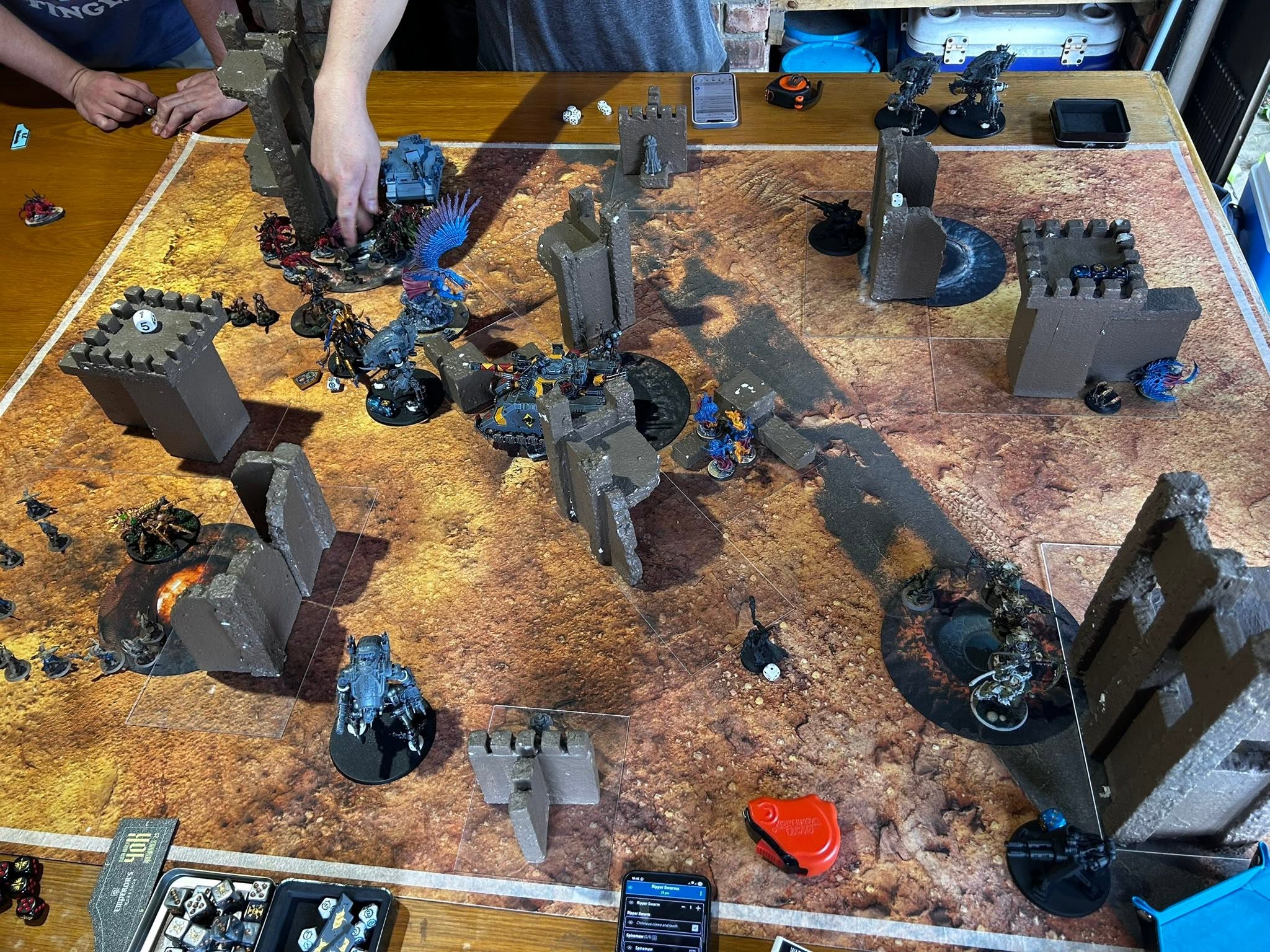 Two members measuring distances on a 40k battlefield